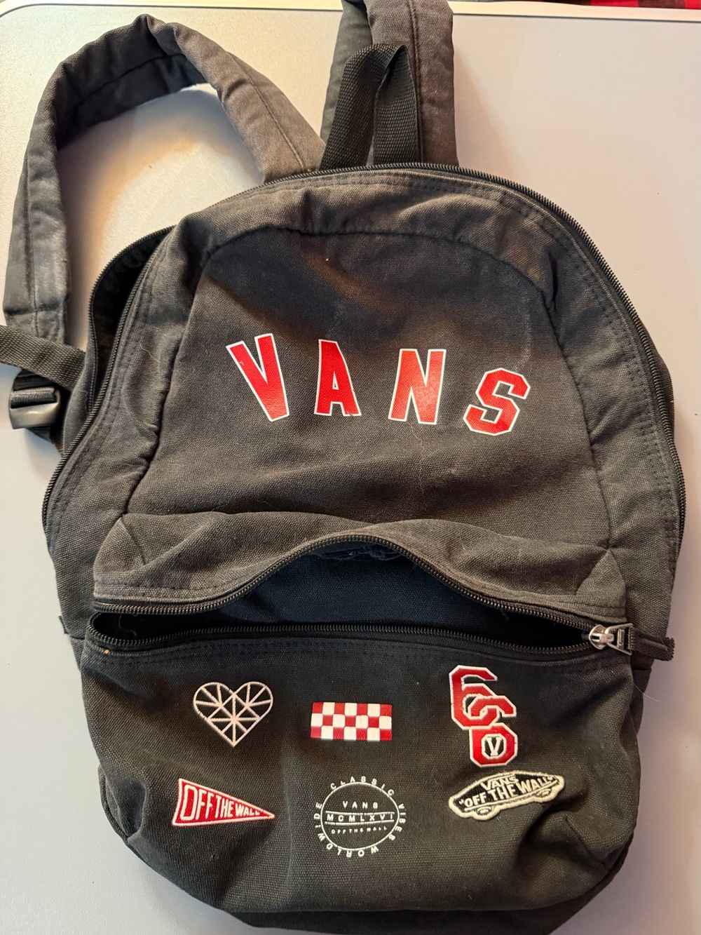 Vans Black Canvas Backpack with Red Lettering and Patch Accents